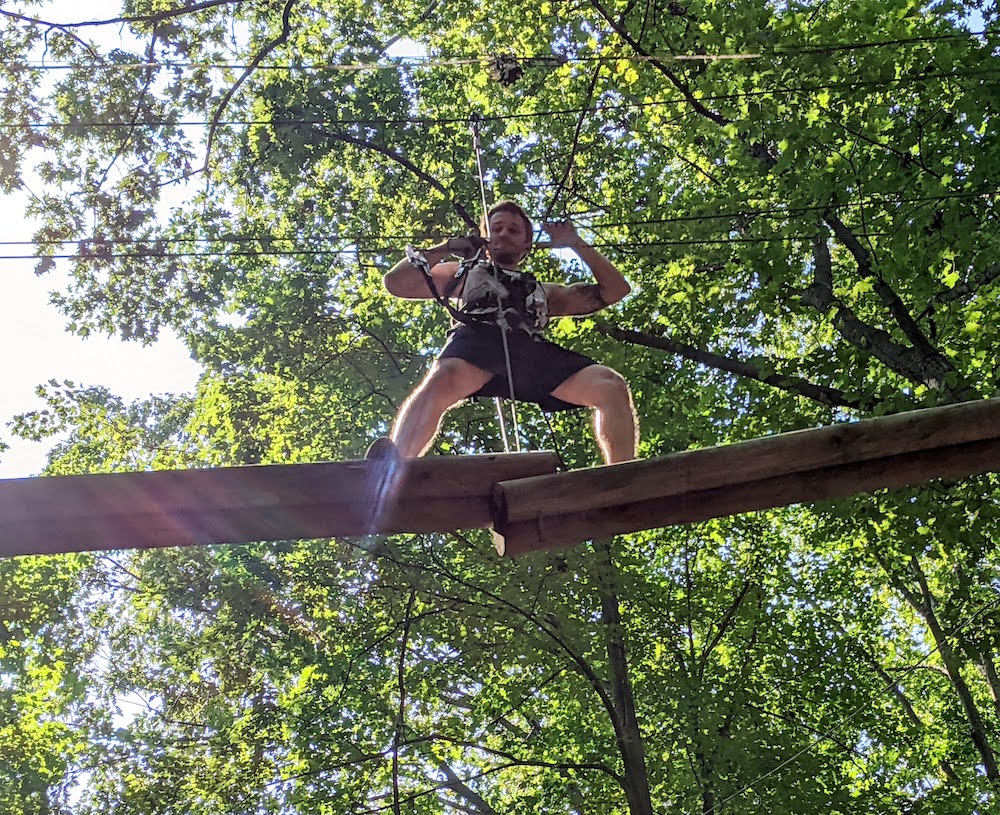 An RTT student celebrates success on the ropes course