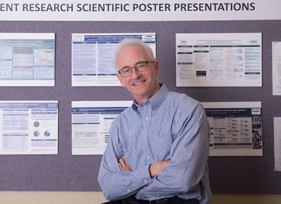 Dr. Paul Kilgore with a research poster