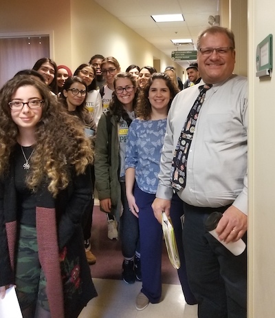 Dr. Phil Pokorski with students in an Applebaum hallway