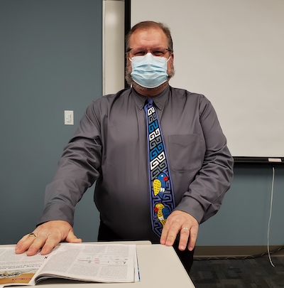 Dr. Phil Pokorski masked and at the front of the classroom