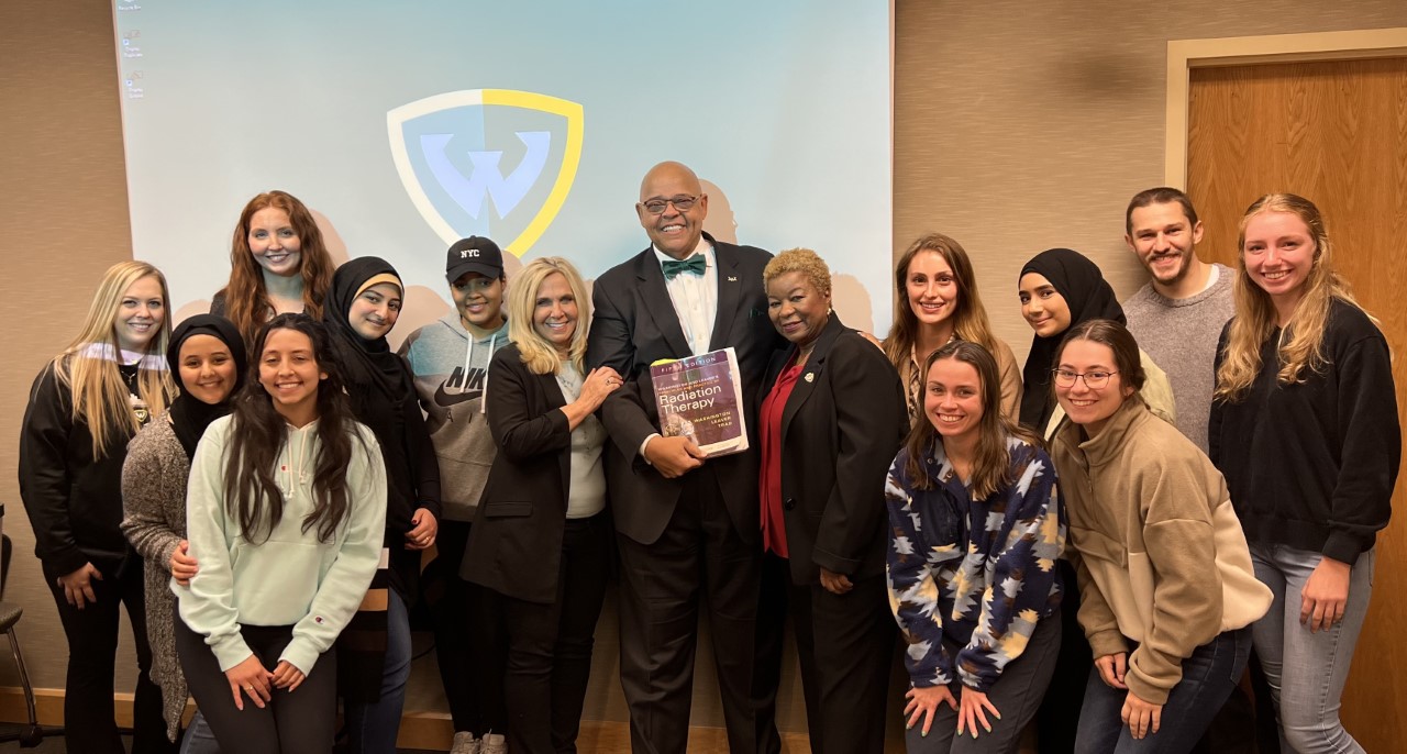 RTT students and faculty with Charles Washington and the texbook he wrote, which is used in programs around the world.