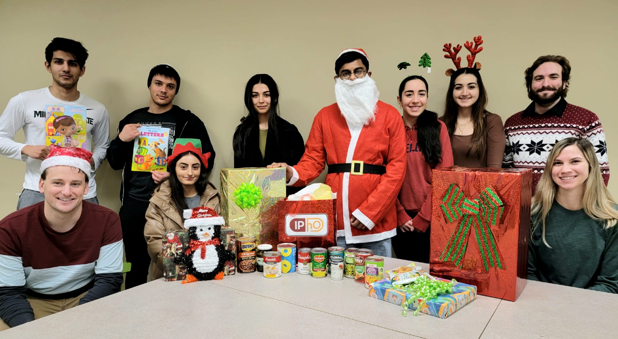 A group of Wayne State pharmacy students with food drive collections.