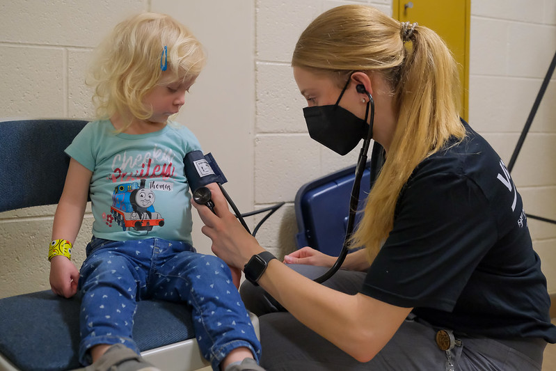 A Wayne State Physician Assistant student takes the blood pressure of a Detroit child